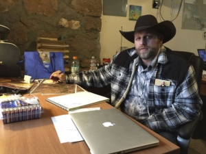 Ammon Bundy sits at a desk he&#039;s using at the Malheur National Wildlife Refuge in Oregon on Friday, Jan. 22, 2016. Bundy is the leader of an armed group occupying a national wildlife refuge to protest federal land policies. The leader of an armed group occupying the refuge met briefly with a federal agent Friday, but left because the agent wouldn&#039;t talk with him in front of the media.