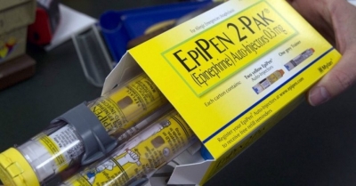 A pharmacist holds a package of EpiPens epinephrine auto-injector, a Mylan product, in Sacramento, Calif., last month. Mylan said it will make available a generic version of its EpiPen, as criticism mounts over the price of its injectable medicine. 