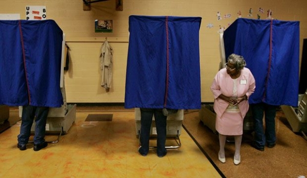 Poll volunteer Ethel Dunson waits for voters to finish casting their ballots in Columbus, Ohio.